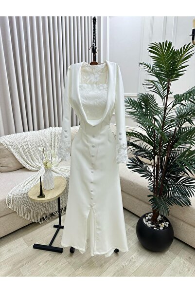 FASHION A formal white dress with a front slit, soft buttons, and elegant Lac...