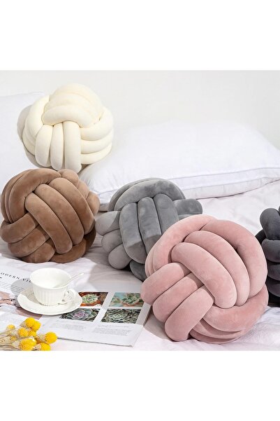 QUINN A round Cushion decorated with a knotted ball design from Queen, a soft...