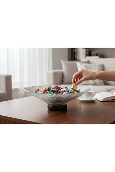 Generic A round glass dish with a black base for serving desserts or fruits.