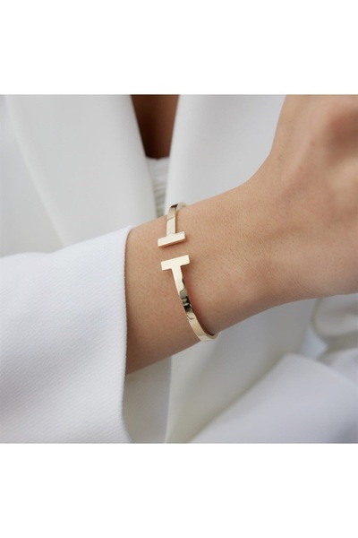 stainless steell سوار من الفولاذ بلون ذهبي مع شريطين متقاطعين