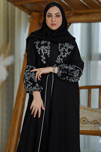 Hasnaa Abaya An abaya with an elegant collar, gathered sleeves, and embroider...