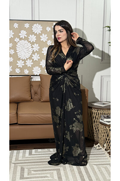 TREASUREISLAND An elegant black evening dress adorned with shimmering gold fl...