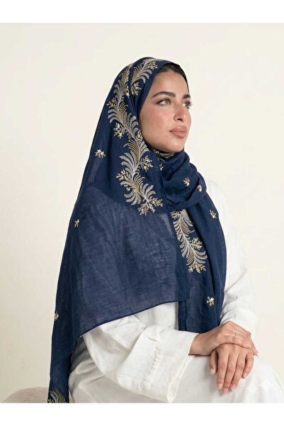 Veil Designer A navy blue hijab with gold and navy embroidery covering the en...
