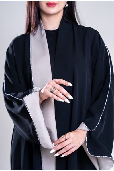 Al Afnan Boutique A distinctive abaya made of black crepe fabric with an eleg...