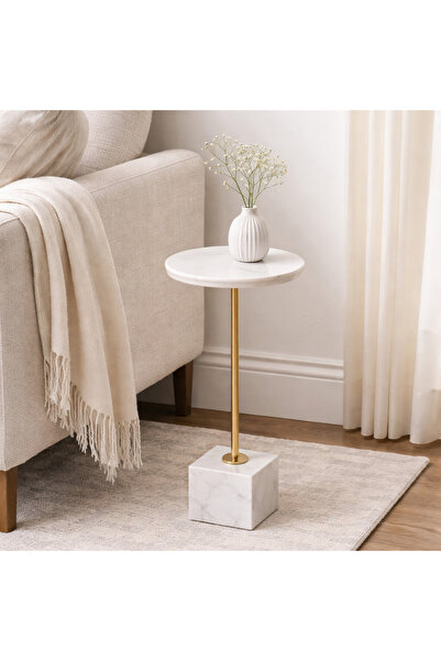 Vi Markets A modern side table with a smooth round marble top, a slim gold me...