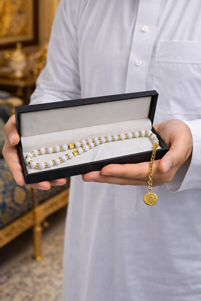 Generic A luxurious white rosary with gold accents – presented in an elegant ...