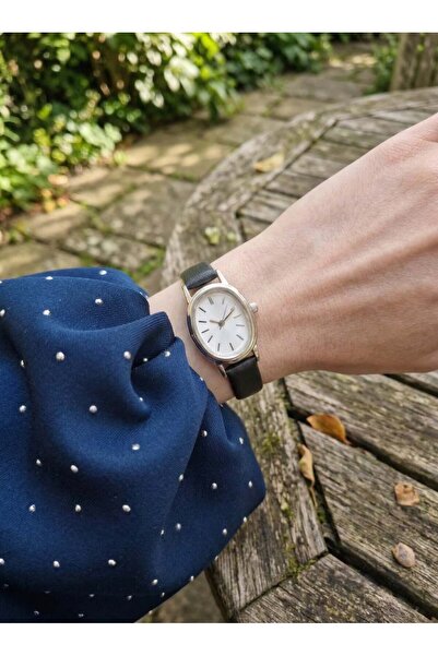 GAMBU Gümüş Renk Beyaz Kadranlı Oval Kasa Siyah Kordon Kadın Kol Saati