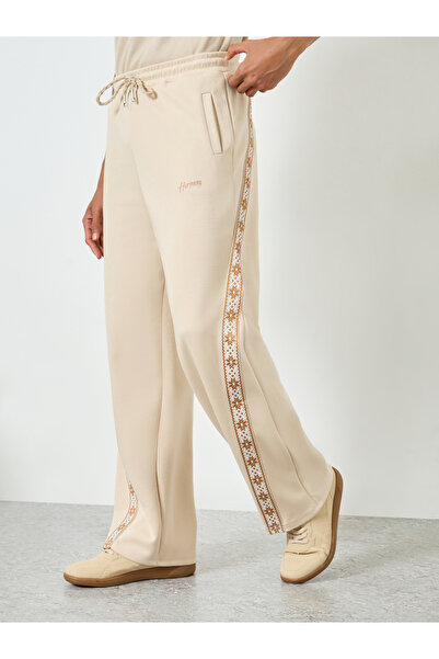 Styli Men Beige Side Taping Print Oversized Joggers