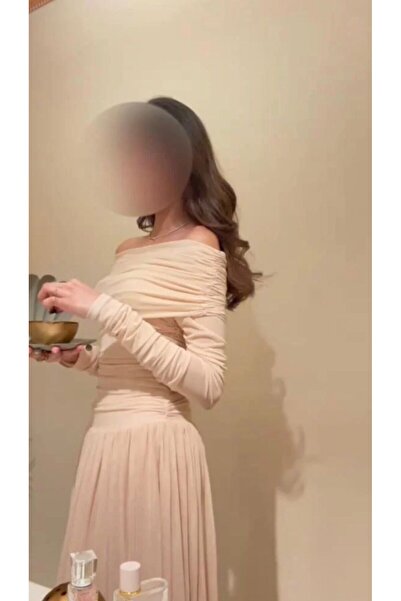 Mira An elegant and striking off-the-shoulder evening dress with skinny, gath...