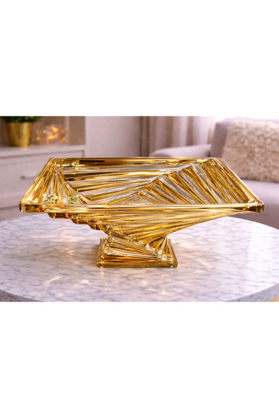 Generic A luxurious glass fruit bowl with a gold base – a touch of elegance f...