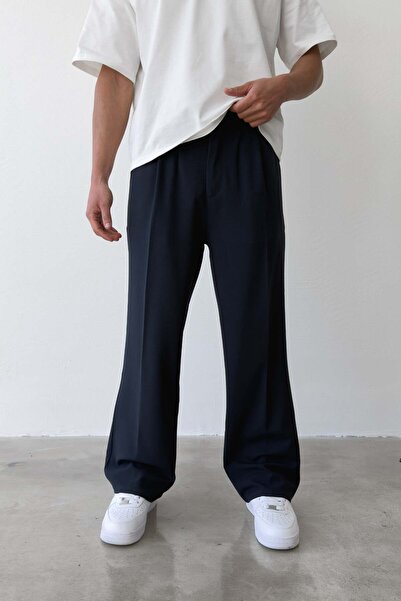 Flaw Wear بنطلون من القماش المطوي ذو تصميم فضفاض باللون الأزرق الداكن