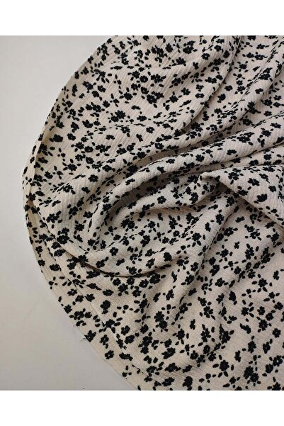 Kumaş Parça Țesătură din jerseu cu flori negre, cu aspect creponat, pe fundal...