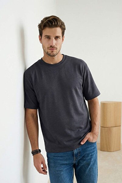 Trendyol Collection تي شيرت إنديجو واردروب إسينشالز ذو أكتاف منخفضة وقصة عادي...