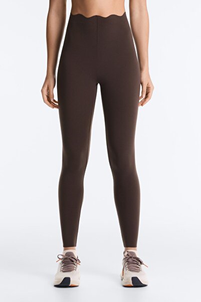 High rise compressive core control leggings at wrist level