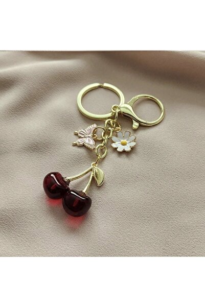 VEYA A stylish keychain with a cherry, butterfly, and flower design – an attr...
