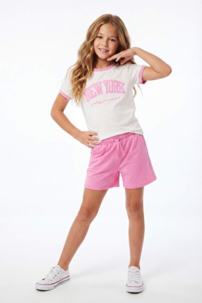 TRENDYOLKIDS Ροζ κορίτσι 100% βαμβακερό σλόγκαν με εμπριμέ κοντομάνικο πλεκτό...