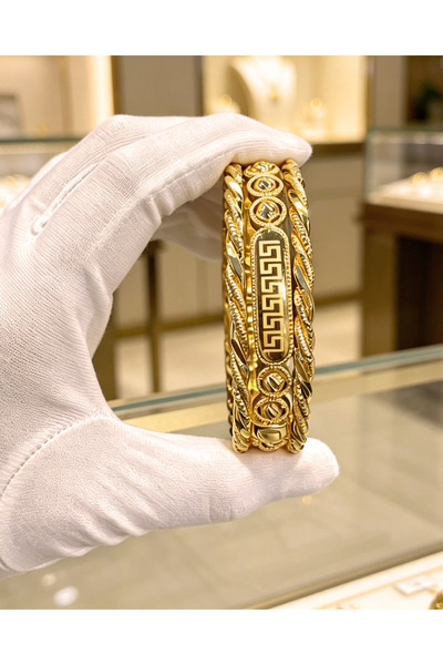 ALZAHR A set of three 24K gold-plated bangles with a twisted rope design, sta...