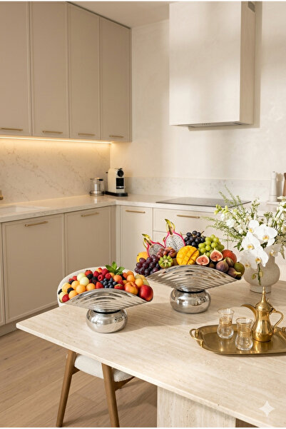 Generic A set of dessert and fruit serving dishes with a luxurious decorative...