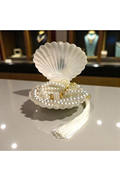 Gifts A set of (12) elegant rosary favors wrapped in a luxurious shell-shaped...