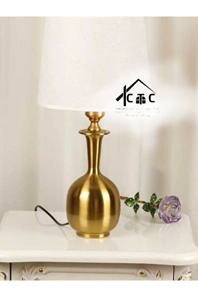 Generic This Is a Modern Gold Table Lamp with a Metal Base in a Vase Design a...