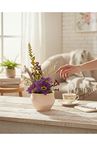 TagerElSaadah Artificial flower arrangement in a decorated clay pot