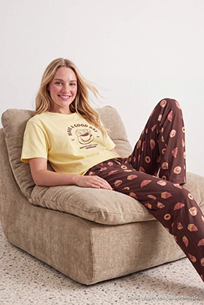 Trendyol Collection طقم بيجامة محبوكة بنمط كرواسون القهوة مطبوع عليه شعار من ...