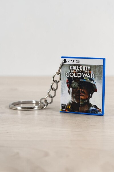 NEORA سلسلة مفاتيح على شكل صندوق ألعاب مصغر لـ Call of Duty: Black Ops Cold War PS5
