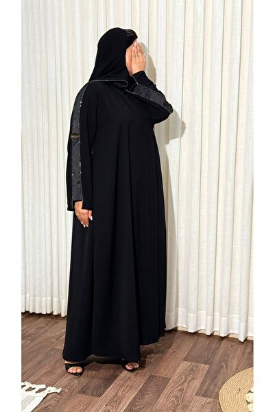 Elegant An elegant abaya made of crepe fabric, decorated with crystals on the...