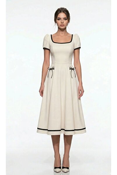 AVARO Fashion Εκρού φόρεμα κοκτέιλ μίντι με διακριτικές φιόγκους και μαύρες λ...