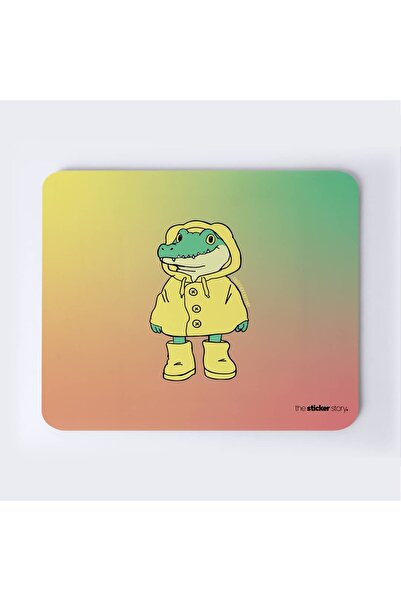 The Mousepad Story. لوحة ماوس على شكل تمساح ترتدي معطفًا واقًا من المطر