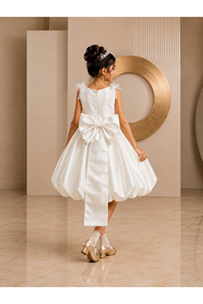 Al Farasha Girl's Off-White Floral Appliqué Bubble Hem Party Dress with Large Back Bow (فستان حفلات بناتي من "الفراشة فاشن" باللون الأبيض الكريمي مع تنورة منفوشة وفيونكة خلفية كبيرة)