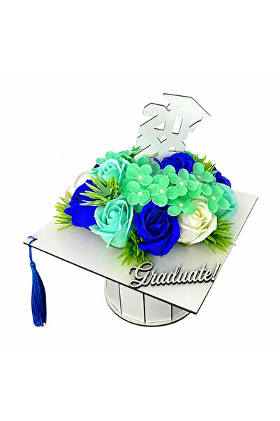 velve Graduation floral arrangement, in a white box in the shape of a toque w...