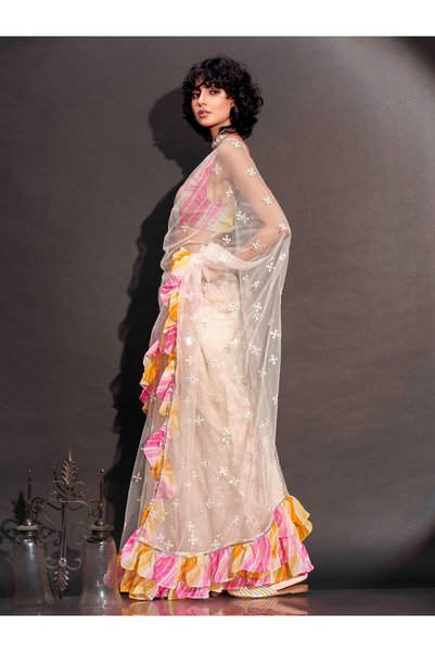 PRASHA Off white colored net saree with faux mirror embroidery and printed lehariya frill on border