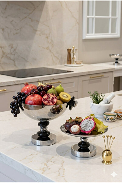 Generic A set of dessert and fruit serving dishes with a luxurious decorative...