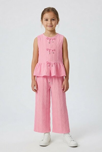 Cansın Mini Bluză roz cu mâneci zero și fundă, pantaloni largi, set 2 piese p...