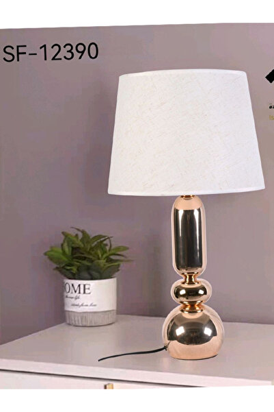 Generic This Lamp Is a Modern Gold-Colored Table Lamp.
