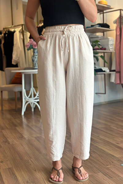 Unique Boutique بنطلون بيج من قماش التينسل بطول الكاحل مع خصر مطاطي