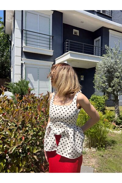 RUZ STUDIOS Black and White Polka Dot Peplum Strap Blouse with Corsage Detail