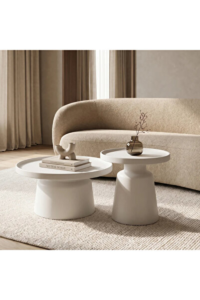 Vi Markets A modern sculptural coffee table set featuring an elegant, minimal...