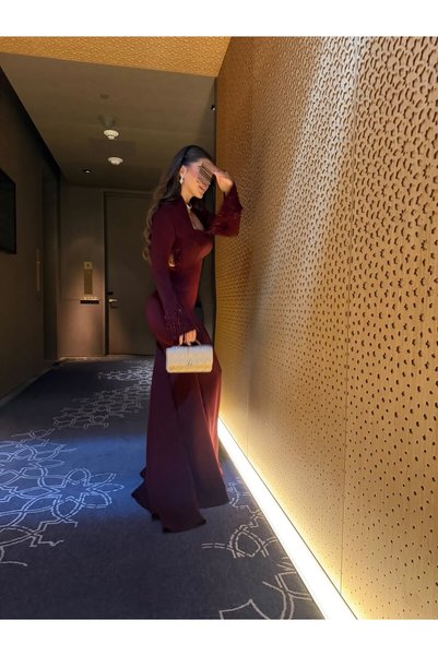Bamah فستان سهرة طويل باللون البرغندي، بقصة أنيقة ومجسمة مع أكمام طويلة وفتحة رقبة مربعة، وتفاصيل خلفية مفتوحة مزينة بتطريز يدوية متدلي تضيف لمسة فاخرة وجذابة