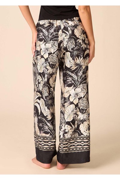 Marilyn Pantaloni Golden Moon din satin moale cu imprimeu tropical în auriu și bej. Croială largă tip culotte, bandă neagră lată în talie și tivuri negre contrastante