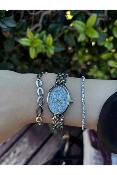 BURCU JEWELRY ساعة يد نسائية فضية اللون بتصميم مميز ومينا بيضاوية – مع سوارين...