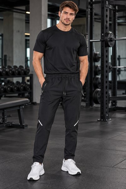 CLAW UP WORK Achilles black tracksuit with pockets and elastic waistband.