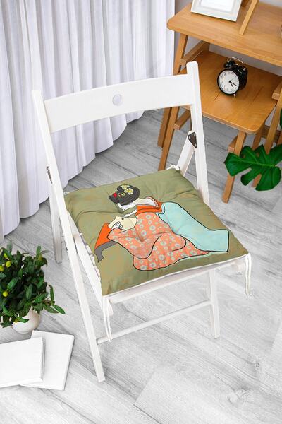 Realhomes Japanka piše na sivoj pozadini uz moderni, mekani jastuk za stolicu...