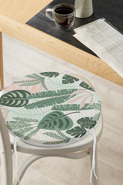 Realhomes Modern Round Zippered Chair Cushion with Dark Colored Leaf Pattern on Soft Colored Floor