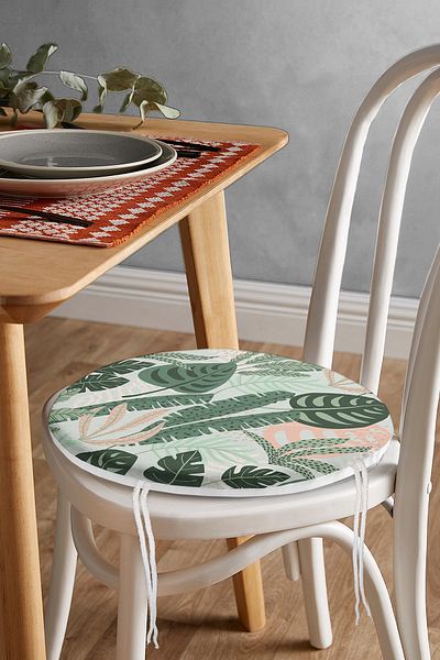 Realhomes Modern Round Zippered Chair Cushion with Dark Colored Leaf Pattern on Soft Colored Floor