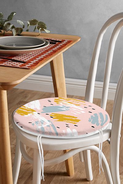 Realhomes Round Zippered Chair Cushion with Water Colored Gold and Blue Drawings on Pink Background