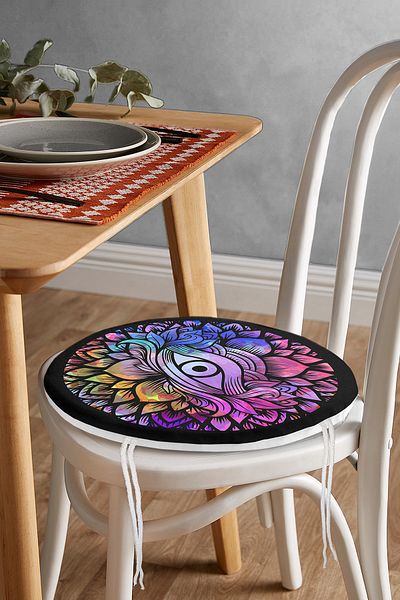 Realhomes Colored Round Chair Cushion on Black Floor with Third Eye Motif