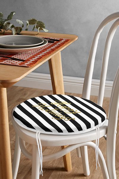 Realhomes Round Zippered Chair Cushion with Black Striped Gold Writing on White Background