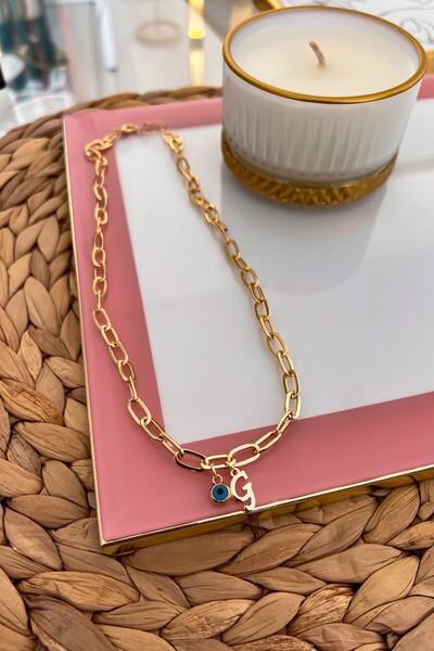 Trendy Butik قلادة سلسلة مشبك ورقة مع حرف G وعين الشر المتدلية